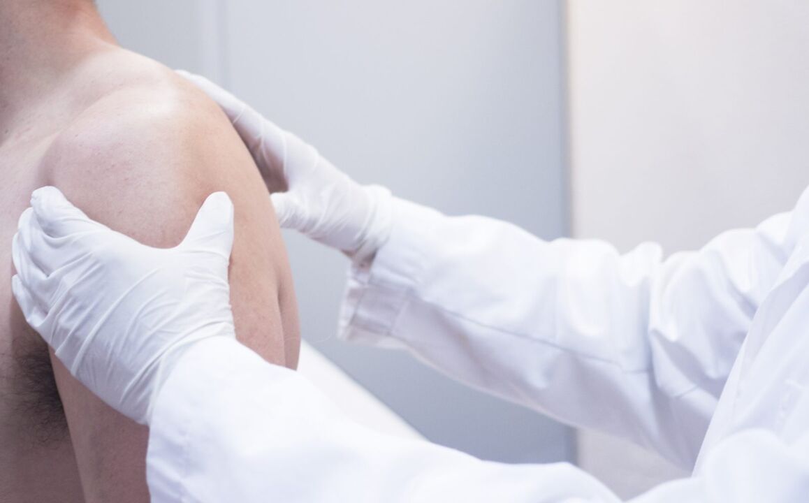 Doctor examining shoulder with joint disease