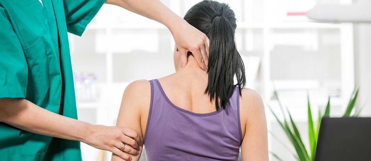 Patient with neck pain is being examined by doctor